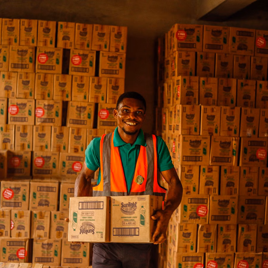 J3 Foods warehouse worker carrying stock